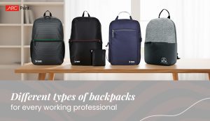 Different types of backpacks displayed on a wooden table - sleek and modern designs in black, navy blue, and grey shades, ideal for working professionals - ARC Print branding.